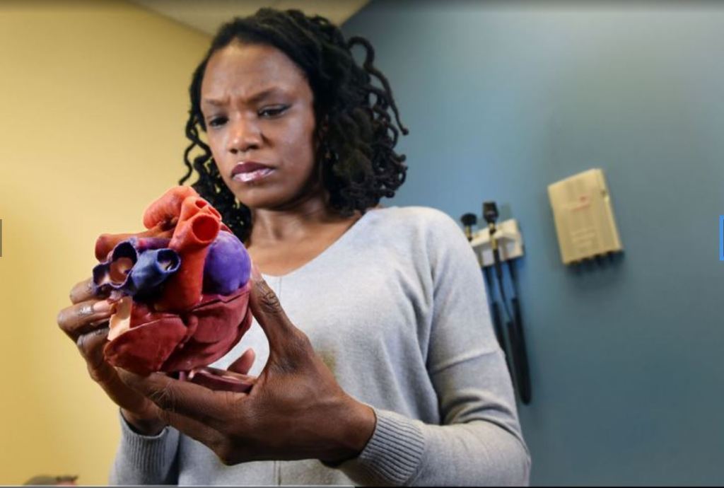 Dr. Carissa Baker-Smith holds a 3D-printed heart.